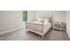 Calm bedroom featuring neutral tones, a well-made bed with white linens and a window looking out on a green yard at 195 Solomon Dr, Cameron, NC 28326