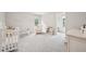 Bright and airy Bedroom with soft gray walls, plush carpeting, and a comfortable glider chair near the crib at 195 Solomon Dr, Cameron, NC 28326