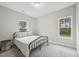 Cozy bedroom featuring a black metal bed frame and sunlit windows at 195 Solomon Dr, Cameron, NC 28326