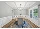 Elegant dining room featuring a coffered ceiling, decorative wainscoting, and a stylish chandelier over the table at 195 Solomon Dr, Cameron, NC 28326