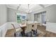 Bright dining room with coffered ceilings, traditional wainscoting, and an eye-catching chandelier above the table at 195 Solomon Dr, Cameron, NC 28326