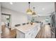 Spacious kitchen island with seating, modern lighting, and seamless transition to living area at 195 Solomon Dr, Cameron, NC 28326