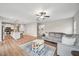 Open-concept living room seamlessly connects with the kitchen, featuring modern furnishings and hardwood flooring at 195 Solomon Dr, Cameron, NC 28326