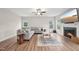 Comfortable living room featuring hardwood floors, a ceiling fan, and a fireplace with a mounted television above at 195 Solomon Dr, Cameron, NC 28326