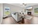 Cozy living room with hardwood floors, a fireplace, and ample natural light from large windows at 195 Solomon Dr, Cameron, NC 28326