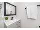 Updated bathroom with gray vanity, black hardware, white countertop, and black framed mirror at 2001 Turtle Point Dr, Raleigh, NC 27604