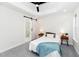 Bright bedroom featuring a sliding barn door, tray ceiling with fan, and ensuite bathroom access at 2001 Turtle Point Dr, Raleigh, NC 27604