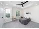 Comfortable bedroom features two windows, ceiling fan, and neutral decor, perfect for relaxation and personalization at 2001 Turtle Point Dr, Raleigh, NC 27604