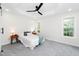 Spacious bedroom featuring plush carpeting, tray ceilings, and ample natural light, creating a cozy retreat at 2001 Turtle Point Dr, Raleigh, NC 27604