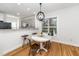 Cozy dining area with hardwood floors, natural light, and modern chandelier at 2001 Turtle Point Dr, Raleigh, NC 27604