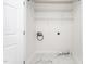 Practical laundry room offers shelving and sleek marbled tile flooring, enhancing efficiency and style at 2001 Turtle Point Dr, Raleigh, NC 27604