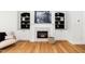 Inviting living room featuring a fireplace, built-in shelving, and hardwood flooring at 2001 Turtle Point Dr, Raleigh, NC 27604