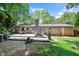 Charming backyard with spacious deck, brick house and green grass at 202 Howland Ave, Cary, NC 27513