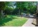 Beautiful backyard showcasing a landscaped lawn, deck, hot tub and outdoor entertainment area at 202 Howland Ave, Cary, NC 27513