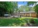 Lush backyard oasis with manicured lawn, deck, and hot tub for outdoor living at 202 Howland Ave, Cary, NC 27513