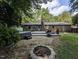 Backyard featuring a hot tub, fire pit, patio, and a brick house, creating an inviting outdoor living space at 202 Howland Ave, Cary, NC 27513