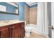 Cozy bathroom featuring a tub and shower combination, vanity with sink and mirror on the wall at 202 Howland Ave, Cary, NC 27513