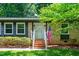 Charming brick home with an American flag, and a welcoming front entrance at 202 Howland Ave, Cary, NC 27513
