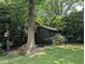 Charming garden shed surrounded by lush greenery, offering practical storage in a serene backyard setting at 202 Howland Ave, Cary, NC 27513