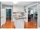 Modern kitchen with granite countertops, white cabinets, and stainless steel appliances, ideal for cooking at 202 Howland Ave, Cary, NC 27513