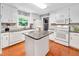 Bright kitchen with granite countertops, white cabinets, and a central island, offering ample workspace at 202 Howland Ave, Cary, NC 27513
