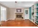 Living room featuring hardwood floors, a brick fireplace, and a back door at 202 Howland Ave, Cary, NC 27513