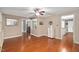 Open-concept living room with hardwood floors, neutral walls, and a ceiling fan at 202 Howland Ave, Cary, NC 27513