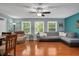 Comfortable living room with hardwood floors, large windows, and a cozy sectional sofa at 202 Howland Ave, Cary, NC 27513