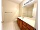 Bathroom features white tile floor, wood vanity and a large mirror at 211 Providence Glen, Chapel Hill, NC 27514