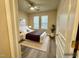 Bright primary bedroom features wood flooring, a ceiling fan and two large windows at 211 Providence Glen, Chapel Hill, NC 27514
