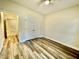 This bedroom features hardwood floors, a ceiling fan and double door closet at 211 Providence Glen, Chapel Hill, NC 27514