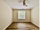Neutral bedroom features hardwood floors, ample space, and a large window for natural light at 211 Providence Glen, Chapel Hill, NC 27514