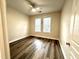 Comfortable bedroom features modern ceiling fan, wood-look floors and large windows with blinds at 211 Providence Glen, Chapel Hill, NC 27514