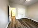 Well-lit bedroom with wood-look floors and a large double door closet at 211 Providence Glen, Chapel Hill, NC 27514