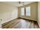 Bright bedroom featuring two sunny windows and wood-look floors at 211 Providence Glen, Chapel Hill, NC 27514