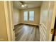 Bright bedroom with two windows, ceiling fan, and attractive wood-look floors at 211 Providence Glen, Chapel Hill, NC 27514