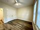 Inviting bedroom with a ceiling fan, wood-look flooring, and bright, natural light at 211 Providence Glen, Chapel Hill, NC 27514