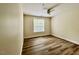 A cozy bedroom features hard wood flooring and a neutral color scheme at 211 Providence Glen, Chapel Hill, NC 27514