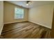 Bedroom has laminate wood flooring, a window, and neutral paint throughout at 211 Providence Glen, Chapel Hill, NC 27514