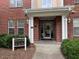 Building 200 entrance with covered walkway, brick facade, and manicured shrubs at 211 Providence Glen, Chapel Hill, NC 27514