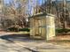 Covered bus stop on the side of a road, surrounded by trees and greenery at 211 Providence Glen, Chapel Hill, NC 27514