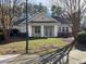 Community clubhouse, surrounded by a green lawn and bare trees at 211 Providence Glen, Chapel Hill, NC 27514