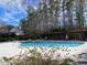 A beautiful blue community pool is surrounded by a wooded area on a sunny day at 211 Providence Glen, Chapel Hill, NC 27514