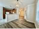 Dining room featuring hardwood floors, a decorative chandelier, and an open view of the kitchen at 211 Providence Glen, Chapel Hill, NC 27514