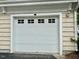 An up-close front exterior view of the white garage door at 211 Providence Glen, Chapel Hill, NC 27514