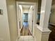 Hallway features white trim and frames, wood floors, and doorways to rooms on either side at 211 Providence Glen, Chapel Hill, NC 27514
