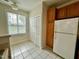Well-lit kitchen showcases tile flooring, ample cabinet space, and a view to the outside at 211 Providence Glen, Chapel Hill, NC 27514