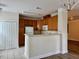 Bright kitchen with wood cabinets, white appliances, and breakfast bar at 211 Providence Glen, Chapel Hill, NC 27514