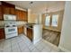 Open kitchen with tile floors, wood cabinetry, white appliances, and an eating area at 211 Providence Glen, Chapel Hill, NC 27514