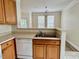 Cozy kitchen features wooden cabinets and white appliances at 211 Providence Glen, Chapel Hill, NC 27514